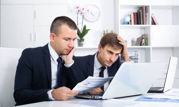 istock Two sad men coworkers in firm office 944663050