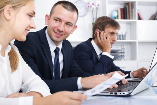 istock Positive coworkers working and talking on phone 944663142