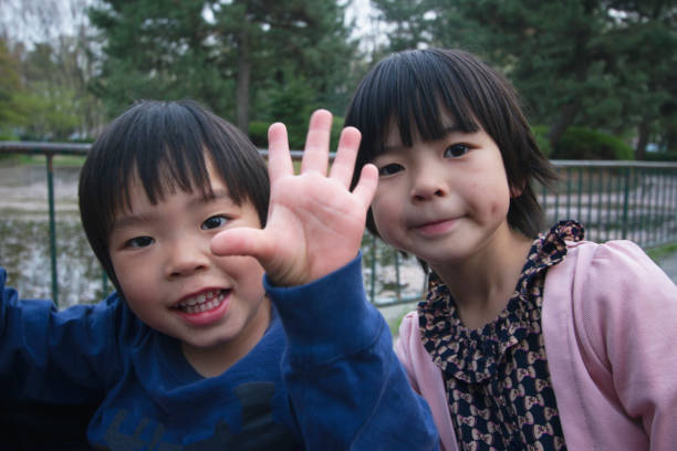 istock Sister and boy showing his hand open 944666312