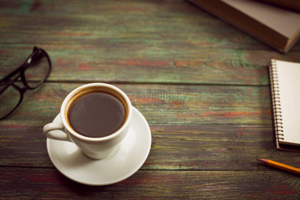 istock A cup of coffee in the workplace on a wooden table. 944667406