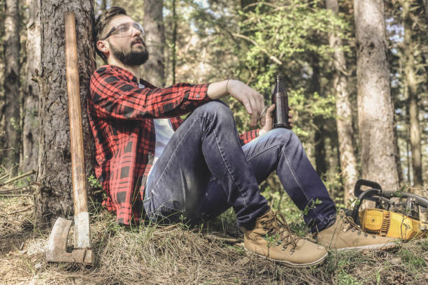 istock lumberman, woodcutter sitting with his ax 944672830