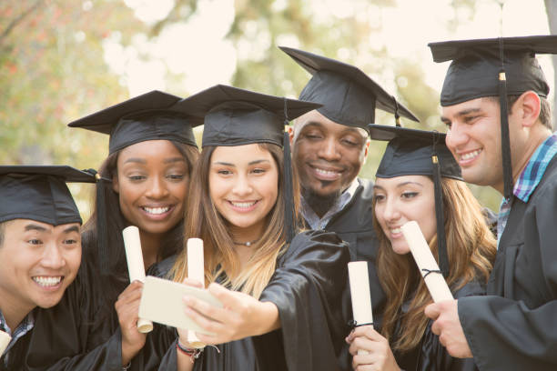 istock College student friends take selfie after graduation ceremony. 944673152
