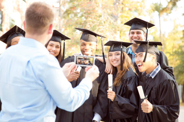 istock College students and father after graduation ceremony. 944673488