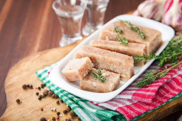 Photo of Homemade jelly meat with mustard  on the table. Holodets. Selective focus. Copy space.