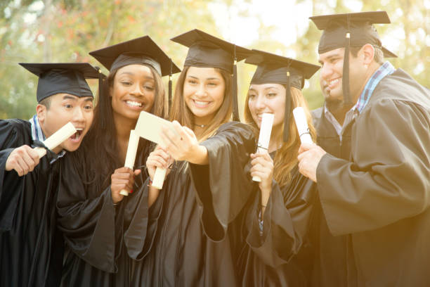 istock College student friends take selfie after graduation ceremony. 944675670