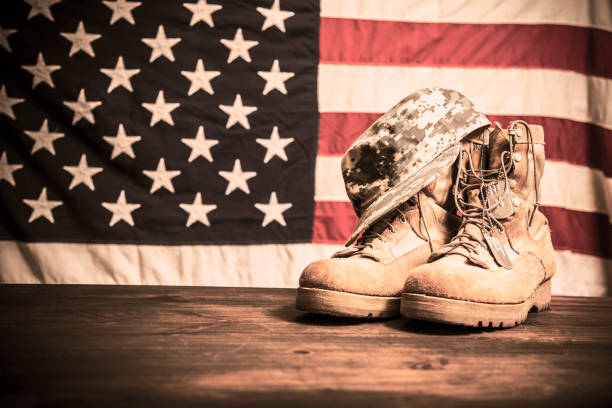 istock USA Military boots, hat and dog tags with flag. 944676578