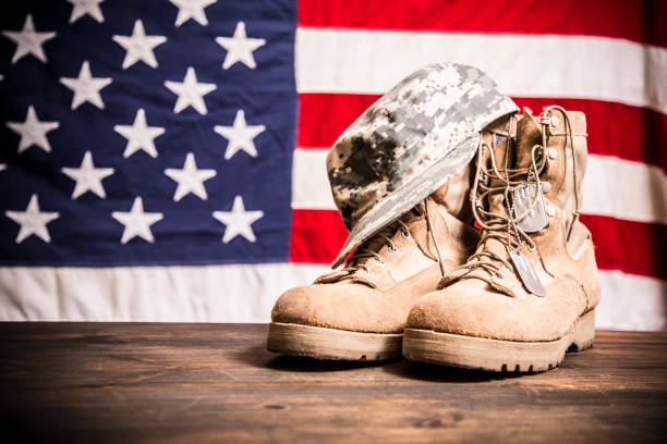 istock USA Military boots, hat and dog tags with flag. 944676836