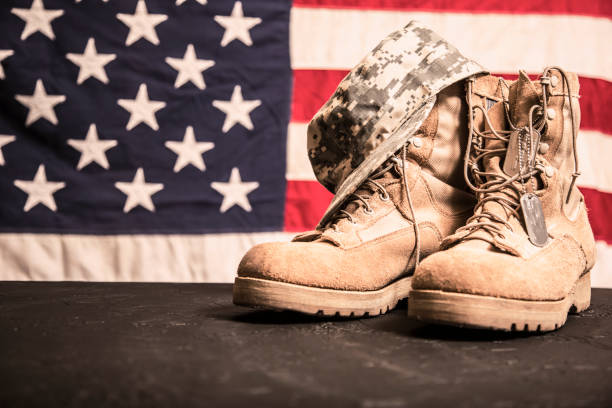 istock USA Military boots, hat and dog tags with flag. 944676894