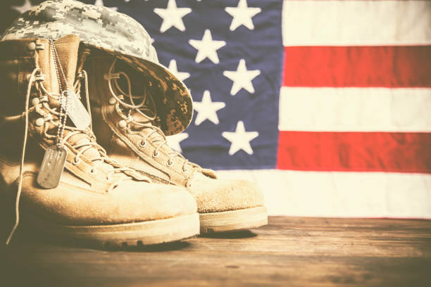 istock USA Military boots, hat and dog tags with flag. 944677112