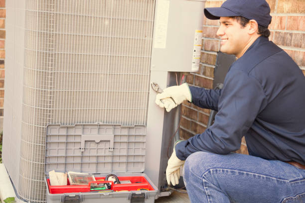 istock Blue collar air conditioner repairman at work. 944677802