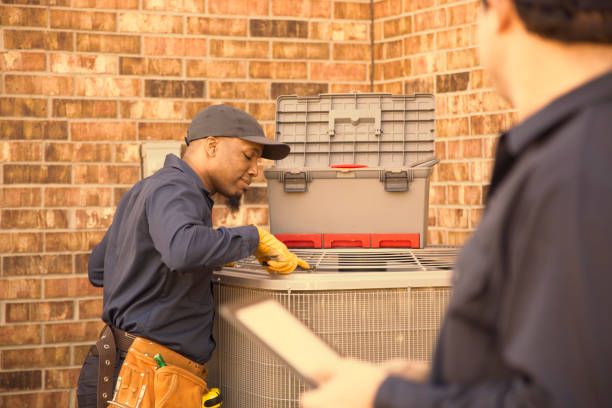 istock Multi-ethnic team of blue collar air conditioner repairmen at work. 944678398
