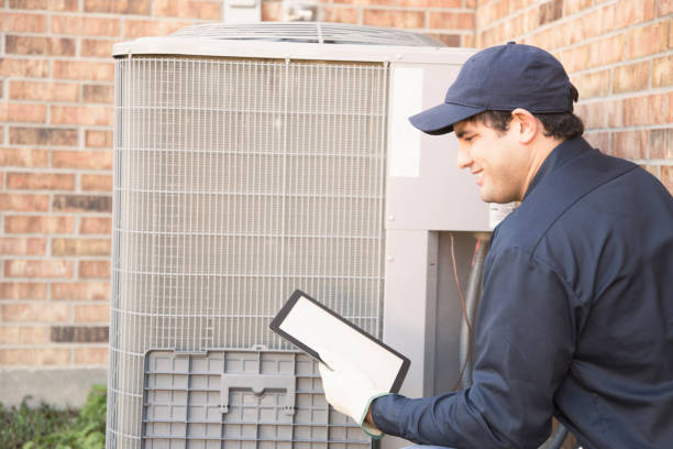 istock Blue collar air conditioner repairman at work. 944678730
