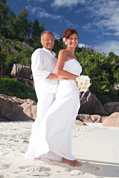 istock wedding couple in white and barefoot 94468323