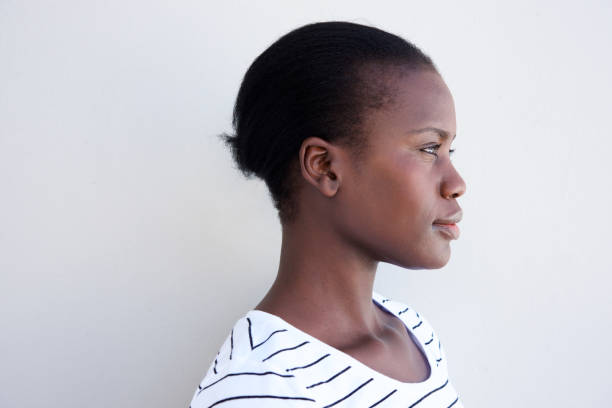 istock Close up profile young black woman against white wall 944685658