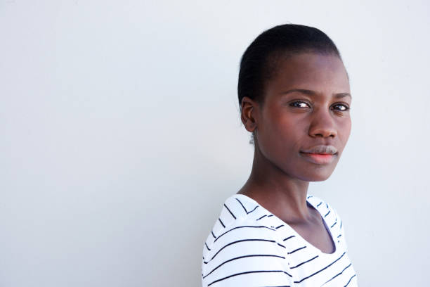 Close up attractive young black woman with serious expression Close up portrait of attractive young black woman with serious expression mesmerised stock pictures, royalty-free photos & images