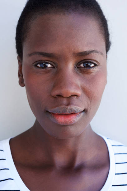 istock Close up beautiful young african woman face with serious expression 944685702