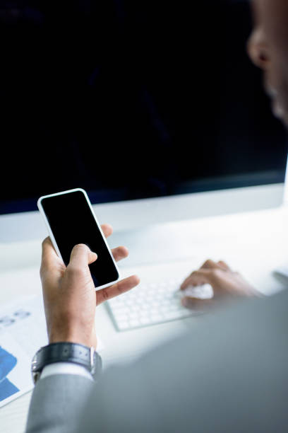 istock partial view of businessman using smartphone at workplace 944686138