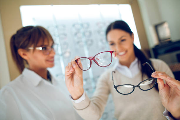 istock Young woman selecting eyeglasses in optical shop 944687234