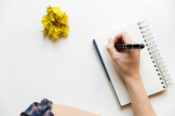 Creative writing concept with notebook and crumpled paper balls. Editing and copywriting workplace.