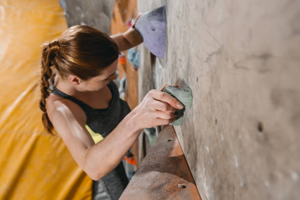 istock woman climbing wall with grips 944691084