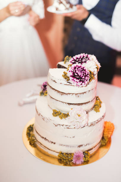 istock Bride and groom at wedding cutting the wedding cake 944699518