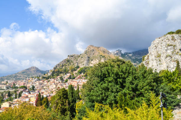 istock Sicilian lanscape with mountains and buildings 944699710