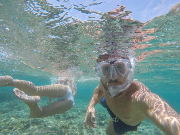 istock Young couple taking selfie underwater, vacations summer concept 944701926