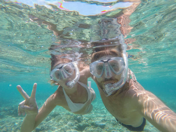 istock Young couple taking selfie underwater, vacations summer concept 944702318