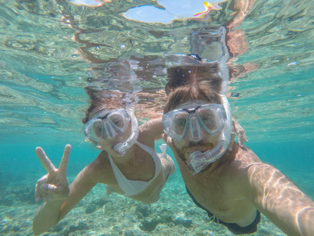 istock Young couple taking selfie underwater, vacations summer concept 944704360