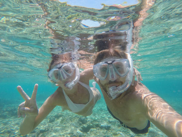 istock Young couple taking selfie underwater, vacations summer concept 944704362