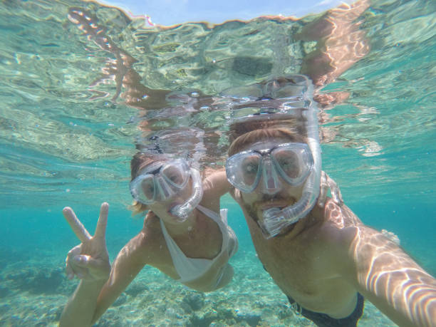 istock Young couple taking selfie underwater, vacations summer concept 944704378
