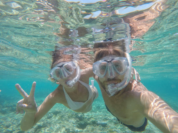 istock Young couple taking selfie underwater, vacations summer concept 944704426