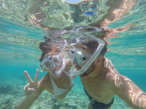 istock Young couple taking selfie underwater, vacations summer concept 944706424