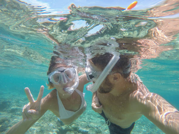 istock Young couple taking selfie underwater, vacations summer concept 944706442
