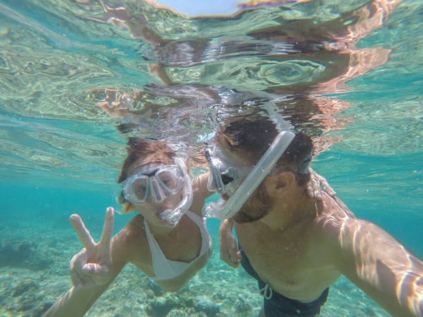 istock Young couple taking selfie underwater, vacations summer concept 944706446