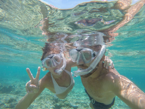 istock Young couple taking selfie underwater, vacations summer concept 944706448