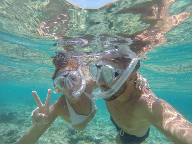 istock Young couple taking selfie underwater, vacations summer concept 944706630