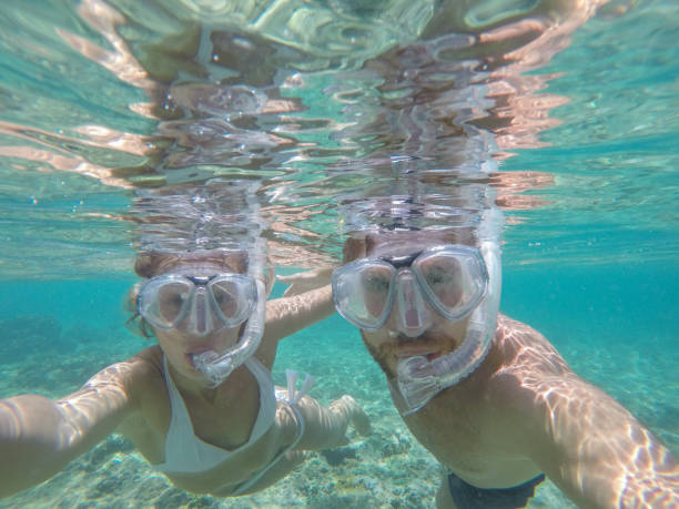 istock Young couple taking selfie underwater, vacations summer concept 944706632