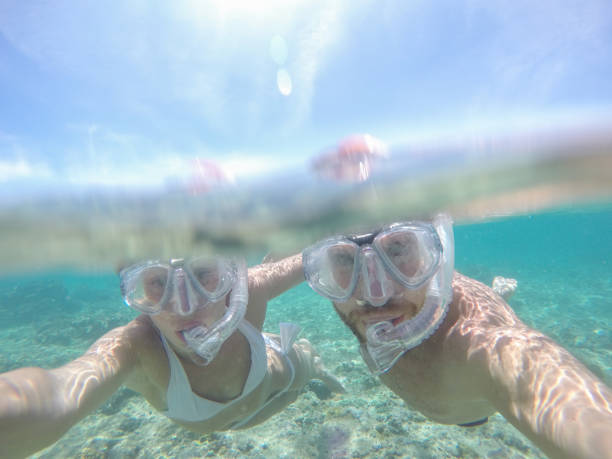 istock Young couple taking selfie underwater, vacations summer concept 944706640