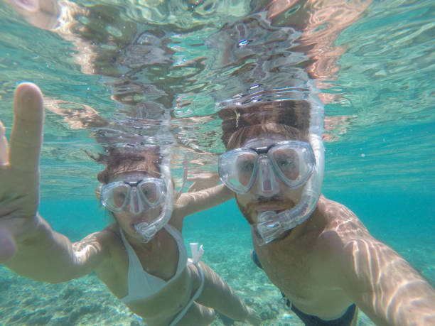 istock Young couple taking selfie underwater, vacations summer concept 944706740
