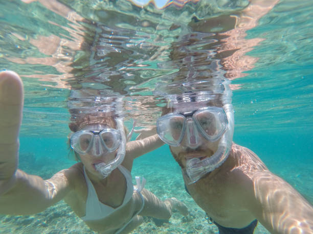 istock Young couple taking selfie underwater, vacations summer concept 944706742