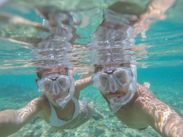istock Young couple taking selfie underwater, vacations summer concept 944706744