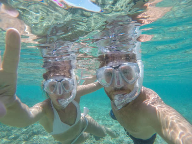 istock Young couple taking selfie underwater, vacations summer concept 944706838