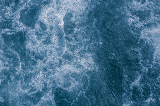 istock Abstract blue sea water with white foam and bubbles for background, natural summer background, pattern concept 944708314