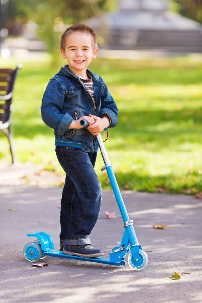 istock Happy boy with scooter in playground 944710522