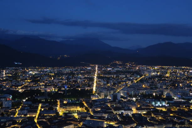 Grenoble, France – July 24, 2017: photography showing the skyline of the city of Grenoble by night. The photography was taken from the Bastille which is the name of the hill in the Chartreuse mountain overlooking the city of Grenoble, France.