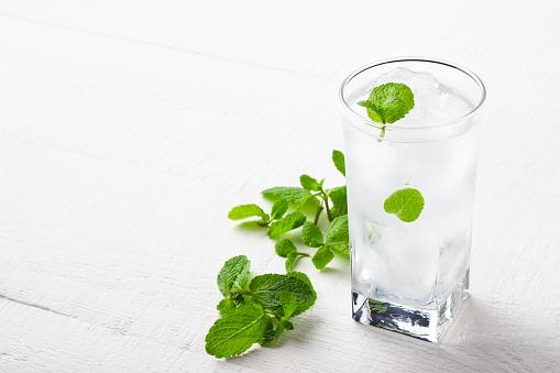 Cold glass of drinking water with ice and mint