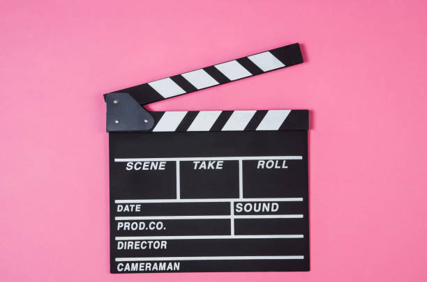 istock Popcorn, movie clip on pink background top view, copy space 944716500
