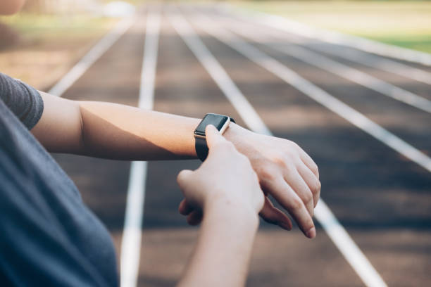 istock Young woman checking progress on smart watch. 944722428