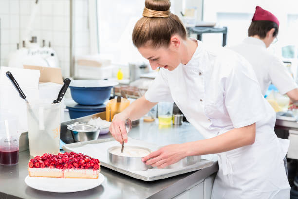 istock Women in pastry shop bakery making pies and cakes 944729052